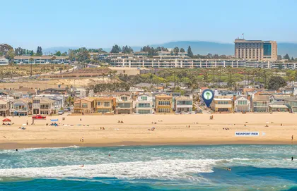 Aerial view of the iconic Newport Beach Peninsula coastline, with wide sandy beaches and the beautiful Pacific Ocean just steps away