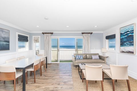 This upstairs unit is elegant yet relaxed, with every design detail inspired by the coastal surroundings. Interior spiral staircase provides access to upper unit from the ground level entry door.