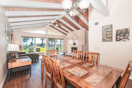 Vantage point from dining room table that looks out onto living area and balcony beyond. Like most homes in this area, this rental does not include central air.