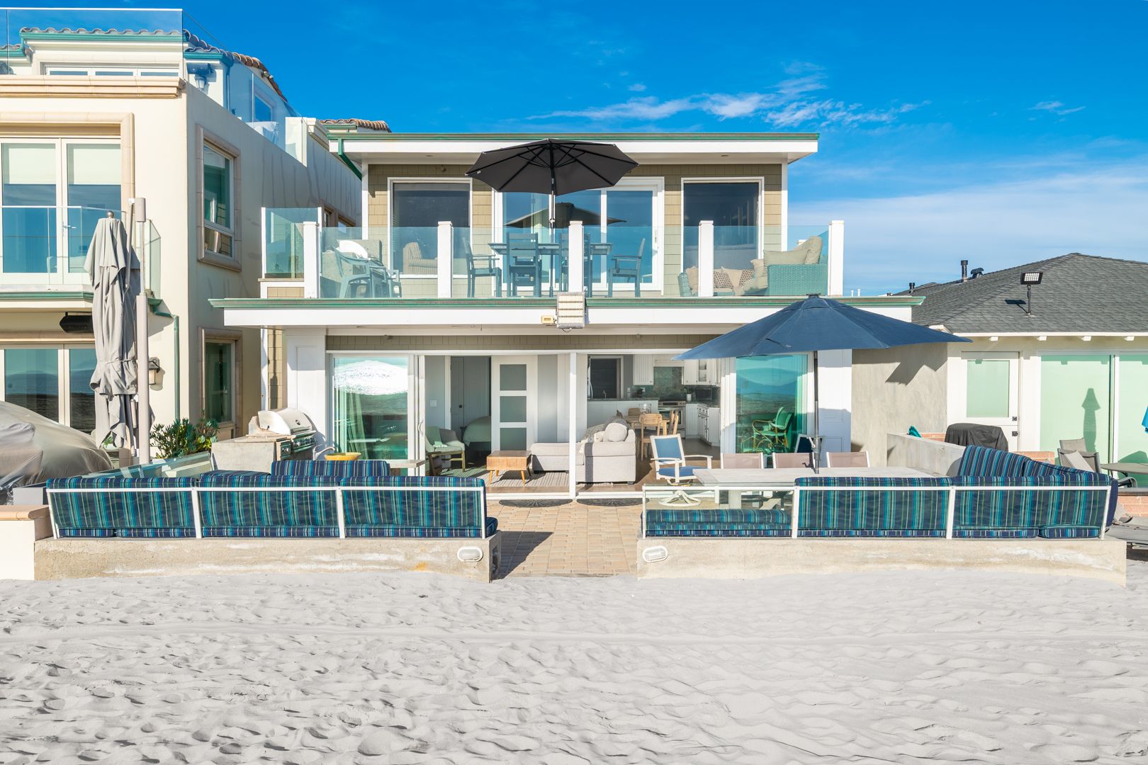 This paired offering is for both the ground-floor and upper residence of this beachfront duplex
