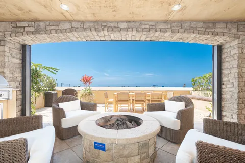 Gather around the oceanfront fire pit with comfortable lounge seating and the beach just beyond