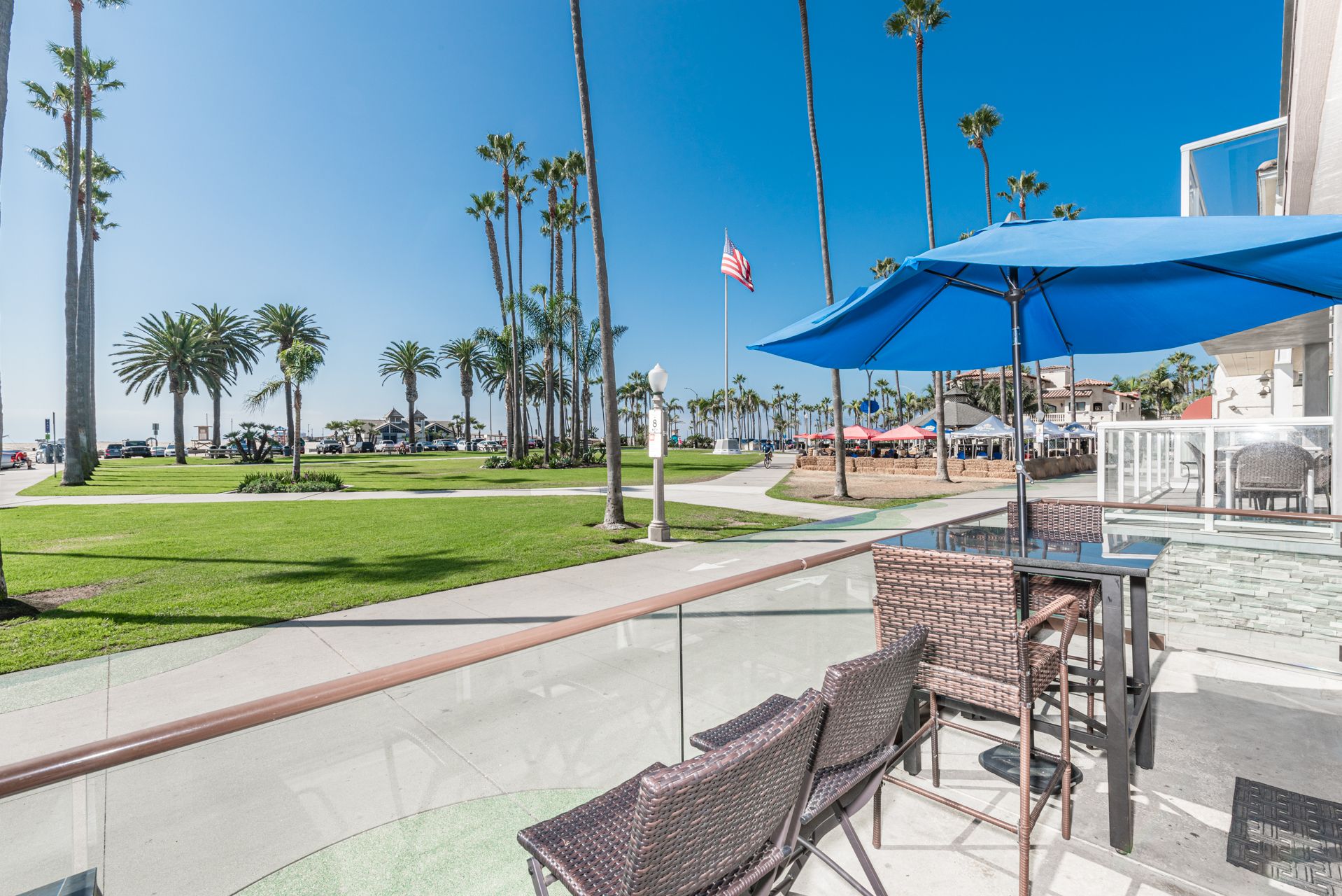The front patio invites effortless coastal living, with views stretching toward the Balboa Pier and sandy shoreline