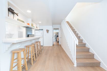 Downstairs hallway leads to one bedroom and en suite bathroom, while stairs lead to three more bedrooms and two more bathrooms.