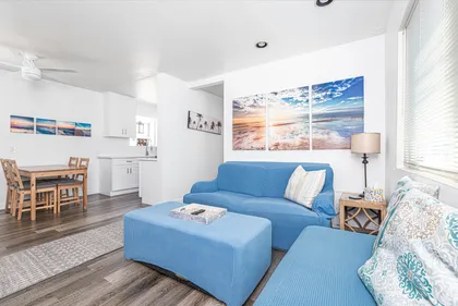 Bright and inviting living space with cozy seating and a seamless flow to the kitchen area