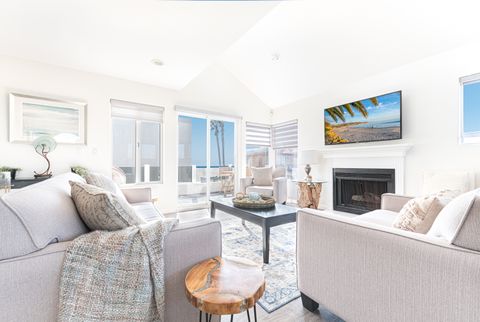 Main living area with panoramic ocean views and sliding doors that open to the front patio