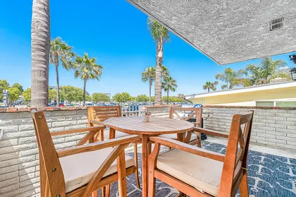 The front patio includes outdoor seating for four and a propane gas BBQ grill, for evening cookouts.
