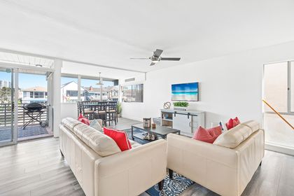 This home's bright interior and stylish beachside motif will sweep you off your feet and straight into vacation mode.