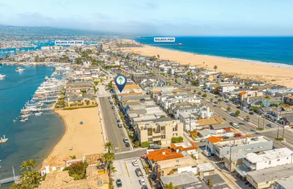 Sweeping aerial perspective of the peninsula highlighting the home’s ideal setting between the ocean and bay