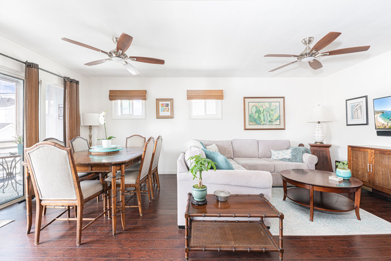 The main living area includes a dining table for 6, sectional couch, cable TV, and sliding doors that open to the balcony.