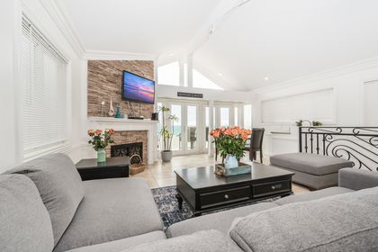 One of two living rooms in the rental, this second level living area includes a large sofa, cable TV, dining table for four, wet bar station, and French doors that lead to your beachfront patio.